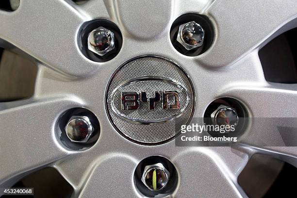 The BYD Co. Logo is displayed on the wheel on an e6 electric vehicle displayed in a showroom at the company's headquarters in the Pingshan district...