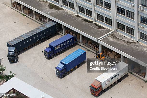 Trucks sit at a logistics building at the BYD Co. Campus in the Pingshan district of Shenzhen, China, on Tuesday, Aug. 5, 2014. Net debt for BYD Co.,...