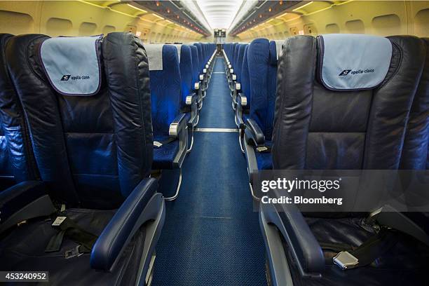 Apollo business class seating stands in front of standard seats in the empty cabin of a Cyprus Airways Public Ltd. Operated Airbus A320 aircraft,...