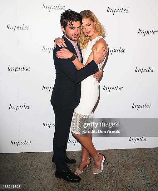 Felix Bloxsom and Erin Heatherton pose for a luxury fragrance launch at Angel & Ash on August 6, 2014 in Sydney, Australia.