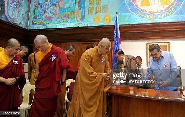 Former Philippine president and now Manila Mayor Joseph Estrada greets Buddhist monks from Hong kong during a courtesy call and a press briefing in...