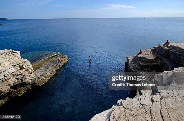 Climber walks over a 'Slackline' at the cliffs of Stoja on August 5, 2014 near Pula, Croatia. The area is known for 'Deep Water Soloing' , free...