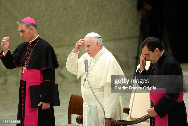 Pope Francis, flanked by Prefect of the Pontifical House and former personal secretary of Pope Benedict XVI, Georg Ganswein , delivers his blessing...