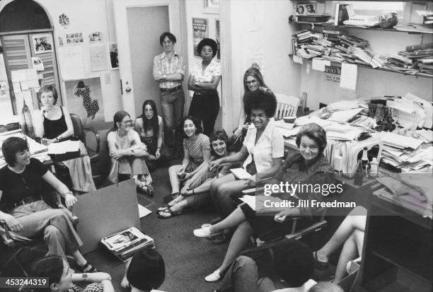 American feminist, journalist, and activist Gloria Steinem at her desk during a staff meeting for Ms. Magazine, New York City, 1975.