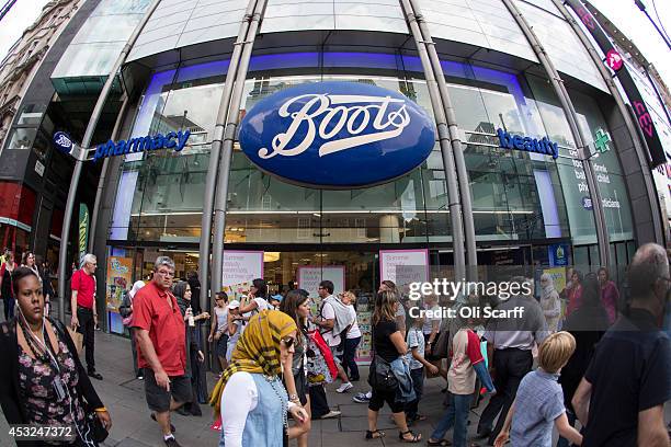 Members of the public walk past a branch of Boots the chemist on Oxford Street on August 6, 2014 in London, England. US pharmacy chain 'Walgreens',...