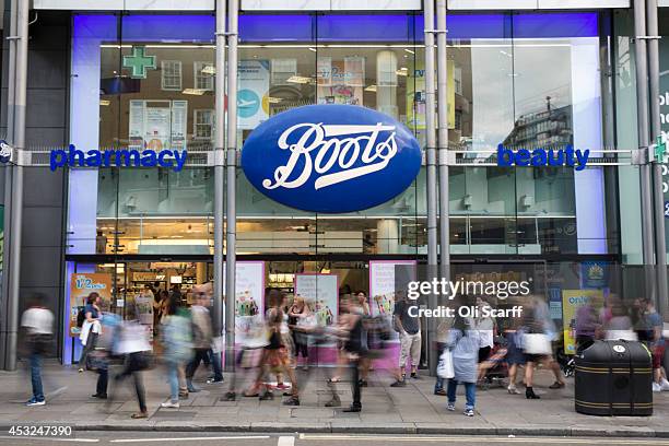 Members of the public walk past a branch of Boots the chemist on Oxford Street on August 6, 2014 in London, England. US pharmacy chain 'Walgreens',...