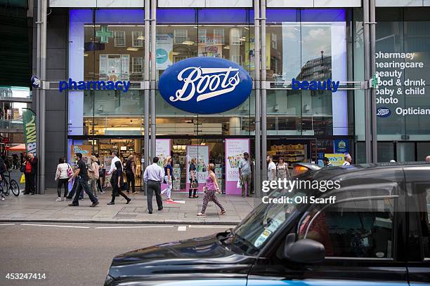 Members of the public walk past a branch of Boots the chemist on Oxford Street on August 6, 2014 in London, England. US pharmacy chain 'Walgreens',...