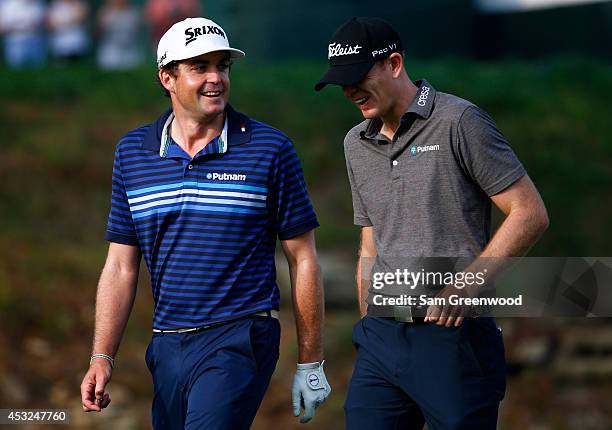Keegan Bradley of the United States walks with Brendan Steele of the United States during a practice round prior to the start of the 96th PGA...