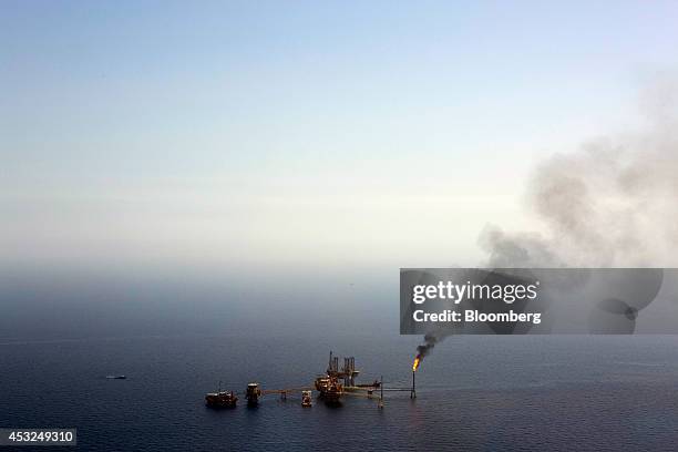 Gas is flared from a tower on an oil drilling rig operated by Petroleos Mexicans in the Ku-Maloob-Zaap oilfield at Campeche Bay off the coast of...