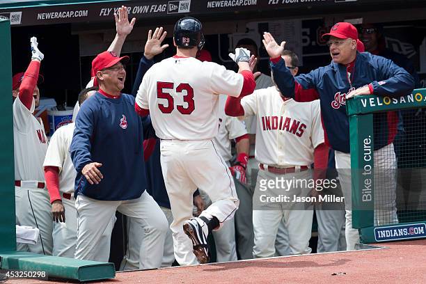 George Kottaras of the Cleveland Indians celebrates with his team after hitting a solo home run during the third inning against the Chicago White Sox...