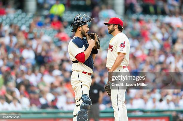Catcher George Kottaras of the Cleveland Indians talks to starting pitcher T.J. House of the Cleveland Indians during the game against the Kansas...