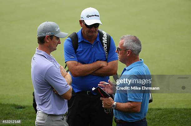 Paul McGinley , European Ryder Cup Captain, talks with Justin Rose of England as caddie Mark Fulcher looks on during a practice round prior to the...