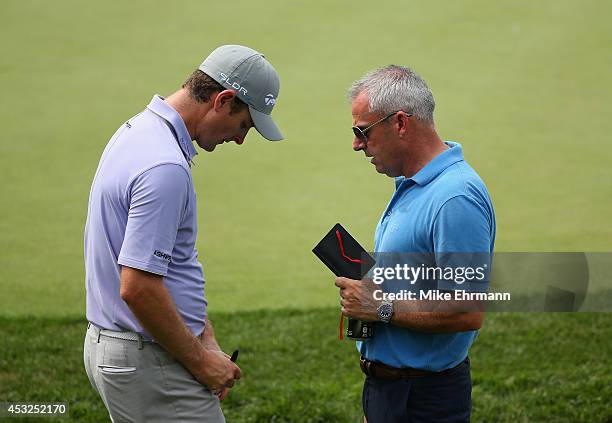 Paul McGinley , European Ryder Cup Captain, talks with Justin Rose of England during a practice round prior to the start of the 96th PGA Championship...