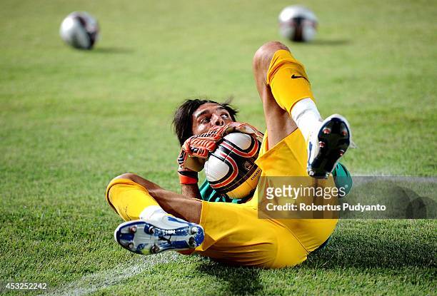 Gianluigi Buffon of Juventus FC saves the ball as he warms up for the pre season friendly match between Indonesia Selection All Star Team and...