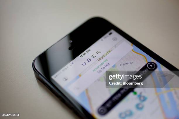 Th Uber Technologies Inc. Car service application is displayed for a photograph on an Apple Inc. IPhone in New York, U.S., on Wednesday, Aug. 6,...