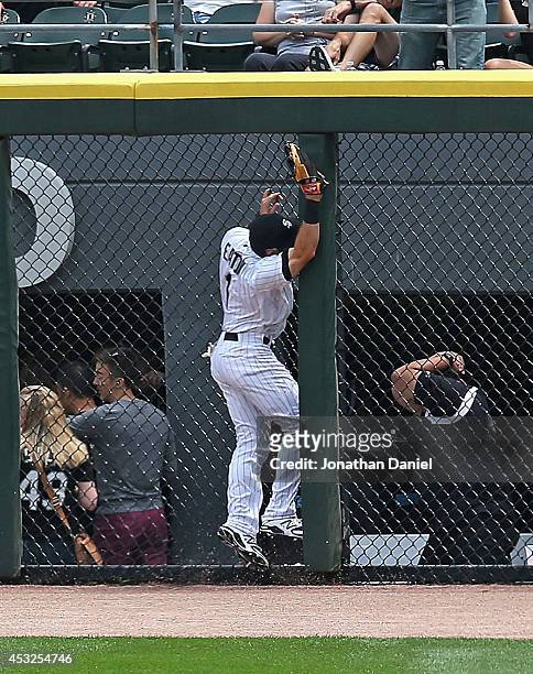 Adam Eaton of the Chicago White Sox runs into the fence trying to make a catch of a home run ball hit by Adam Rosales of the Texas Rangers in the 2nd...