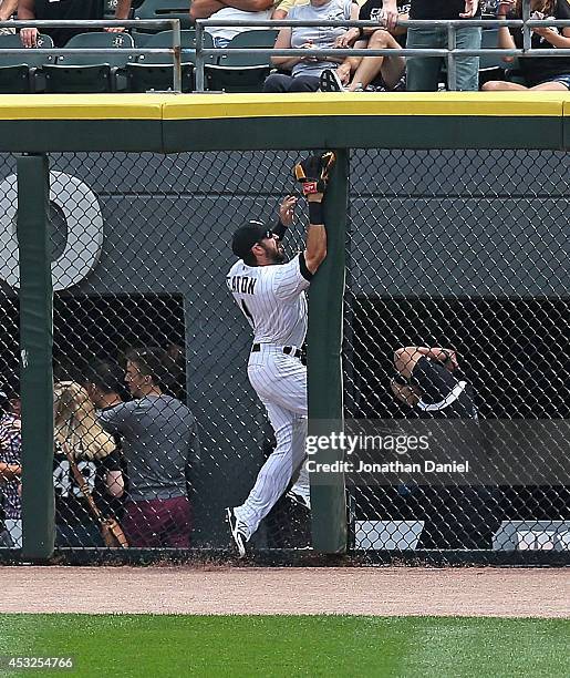 Adam Eaton of the Chicago White Sox runs into the fence trying to make a catch of a home run ball hit by Adam Rosales of the Texas Rangers in the 2nd...