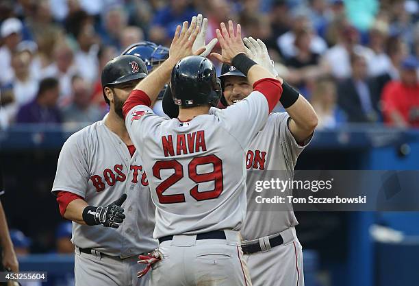 Stephen Drew of the Boston Red Sox is congratulated by Mike Napoli and Daniel Nava after hitting a three-run home run in the third inning during MLB...