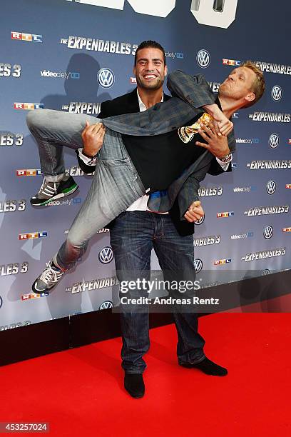 Manuel Charr and Oliver Pocher attend the German premiere of the film 'The Expendables 3' at Residenz Kino on August 6, 2014 in Cologne, Germany.