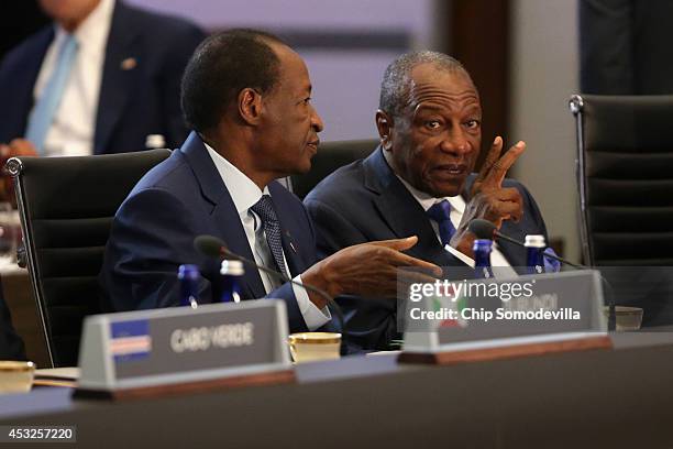 Burkina Faso President Blaise Copaore talks with Guinea President Alpha Conde before the first plenary meeting of the U.S.-Africa Leaders Summit at...