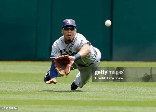 Desmond Jennings of the Tampa Bay Rays dives to catch a ball hit by John Jaso of the Oakland Athletics in the first inning at O.co Coliseum on August...