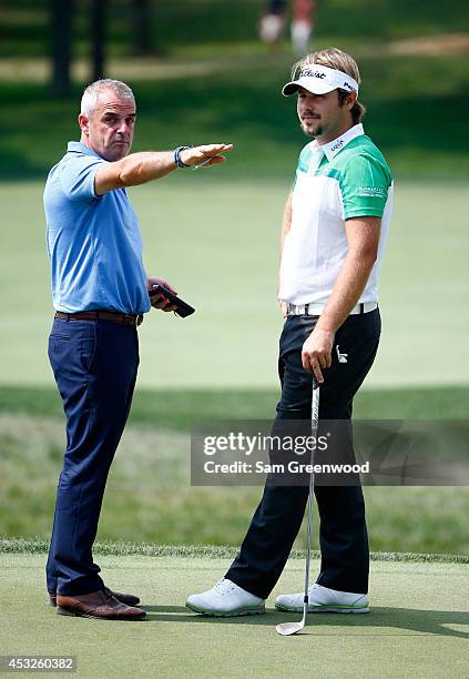 European Ryder Cup captain Paul McGinley talks with Victor Dubuisson of France during a practice round prior to the start of the 96th PGA...