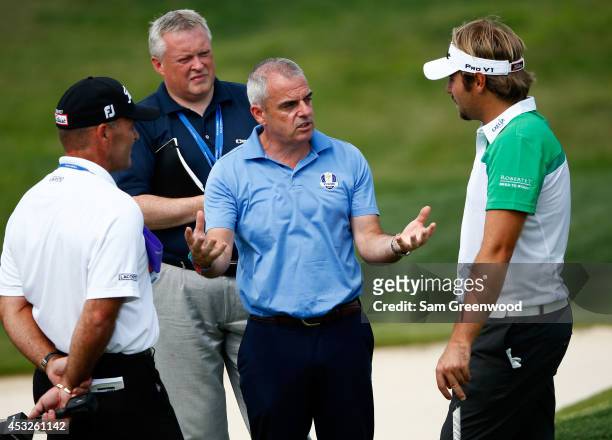 European Ryder Cup captain Paul McGinley talks with Victor Dubuisson of France as Thomas Levet looks on during a practice round prior to the start of...