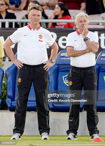 Manager Louis van Gaal and chief opposition scout Marcel Bout of Manchester United follow team warm ups during the pre-season friendly match between...