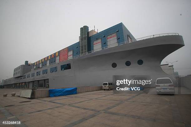 An aircraft carrier shaped building with the covered area of 48818 square meters, the length of 169 meters and the width of 50 meters is seen on...