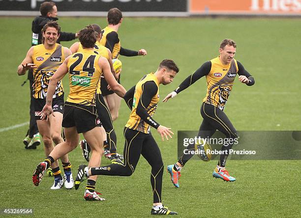 Nathan Foley runs with team-mates during a Richmond Tigers AFL training session at ME Bank Centre on August 7, 2014 in Melbourne, Australia.