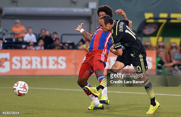 Landon Donovan of MLS All-Stars scores his teams second goal against Dante of Muenchen during the MLS All-Star game between the MLS All-Stars and FC...