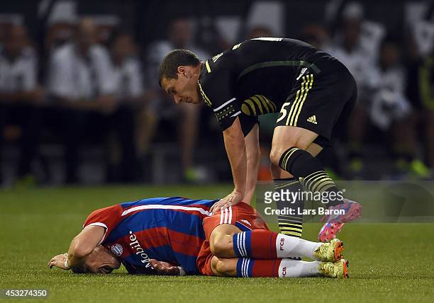 Bastian Schweinsteiger of Muenchen lies on the pitch after a tackle of Matt Besler of MLS All-Stars during the MLS All-Star game between the MLS...