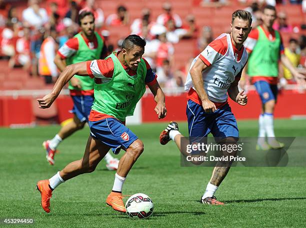 Alexis Sanchez and Aaron Ramsey of Arsenal in action during the Arsenal Training Session at Emirates Stadium on August 7, 2014 in London, England.