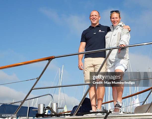 Zara Phillips and Mike Tindall pose for photographs before taking part in the Artemis Challenge race around the Isle of Wight during Cowes Week on...