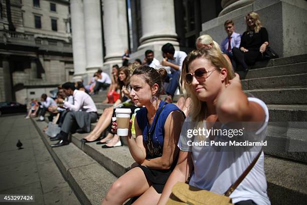 Workers take a lunch break near the Bank of England in the financial district on August 7, 2014 in London, England. The Bank of England has again...