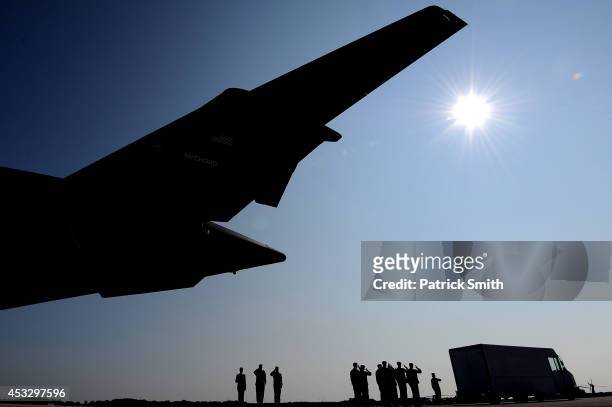 Army soldiers carry the flag-draped transfer case containing the remains of U.S. Army Maj. Gen. Harold J. Greene during a dignified transfer at Dover...