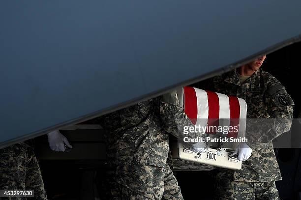 Army soldiers carry the flag-draped transfer case containing the remains of U.S. Army Maj. Gen. Harold J. Greene during a dignified transfer at Dover...