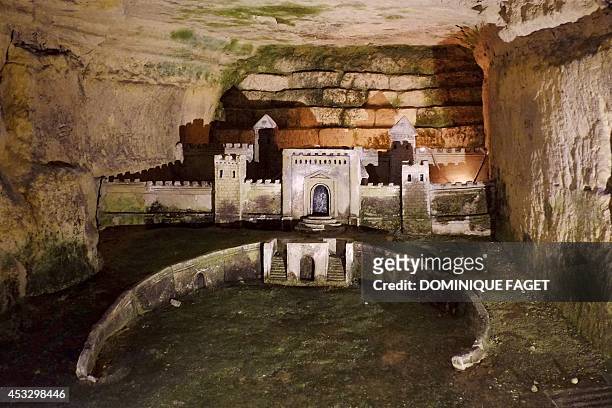 Photo taken on August 7, 2014 at the Catacombs of Paris shows a sculpture made in 1777 by a quarryman named Decure. These underground quarries were...