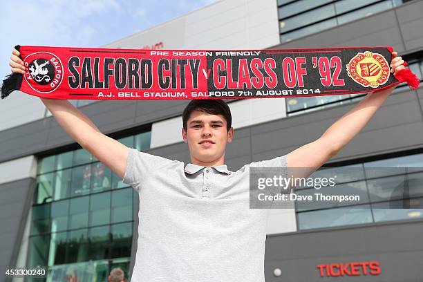 Fan James Nee from Chorlton in Manchester poses with a scarf before the match between Salford City and the Class of '92 XI at AJ Bell Stadium on...