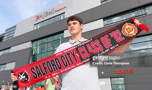 Fan James Nee from Chorlton in Manchester poses with a scarf before the match between Salford City and the Class of '92 XI at AJ Bell Stadium on...