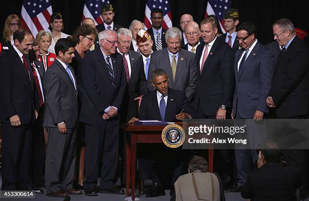 President Barack Obama participates in a signing ceremony for H.R. 3230 as Secretary of Veterans Affairs Robert McDonald, Rep. Raul Ruiz , Rep....