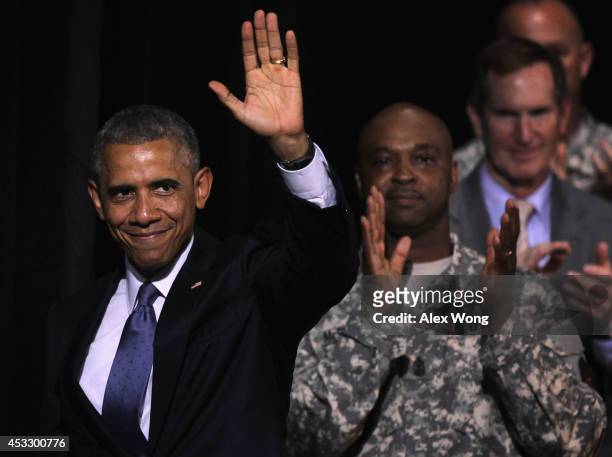 President Barack Obama waves as he leaves after a signing ceremony of H.R. 3230 August 7, 2014 at Wallace Theater in Fort Belvoir, Virginia....
