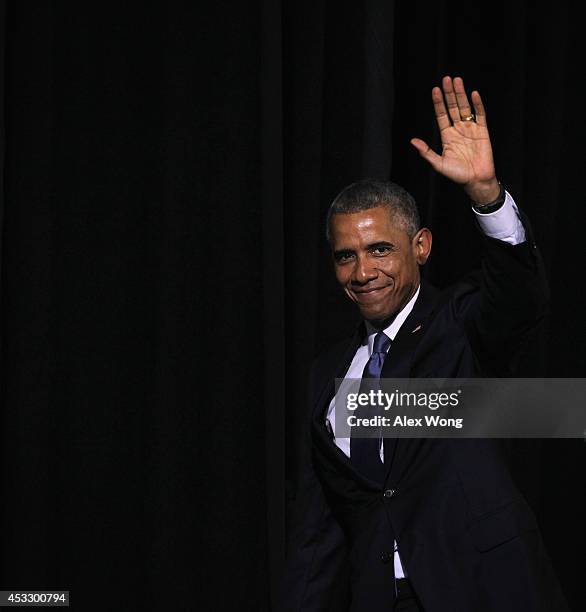 President Barack Obama waves as he leaves after a signing ceremony of H.R. 3230 August 7, 2014 at Wallace Theater in Fort Belvoir, Virginia....