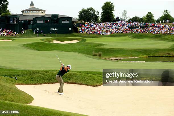 Adam Scott of Australia hits his second shot from a bunker on the 18th hole during the first round of the 96th PGA Championship at Valhalla Golf Club...