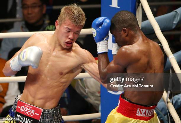 Champion Tomoki Kameda of Japan exchanges punches with Immanuel Naidjala of Namibia during their WBO Bantamweight title bout at the Bodymaker...