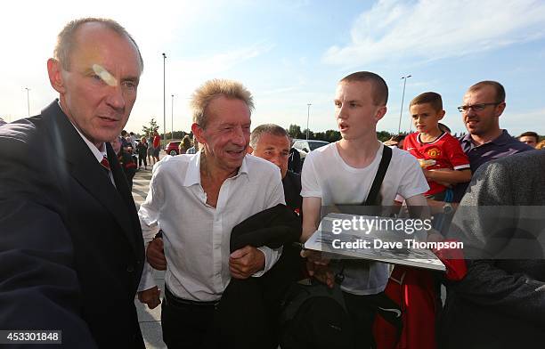 Former Manchester United footballer Denis Law arrives the match between Salford City and the Class of '92 XI at AJ Bell Stadium on August 7, 2014 in...