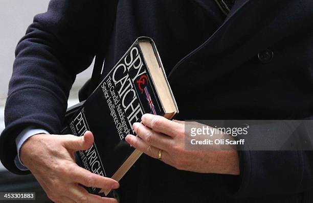 Alan Rusbridger, the Editor of the Guardian newspaper, carries a copy of Peter Wright's book 'Spycatcher' as he arrives at Portcullis House to face...