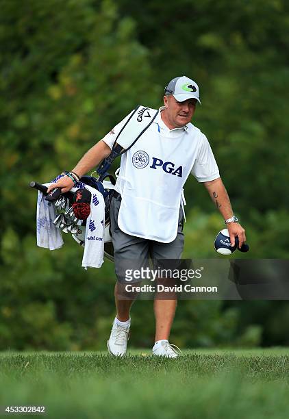 Caddie Dominic Bott is seen during the first round of the 96th PGA Championship at Valhalla Golf Club on August 7, 2014 in Louisville, Kentucky.