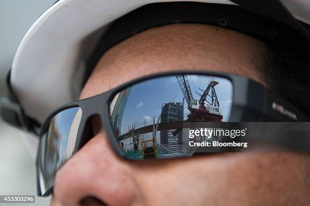 The reflection of a crane cabin and the BBVA Bancomer building are are seen in the sunglasses of a worker at the site of the Torre Reforma building...