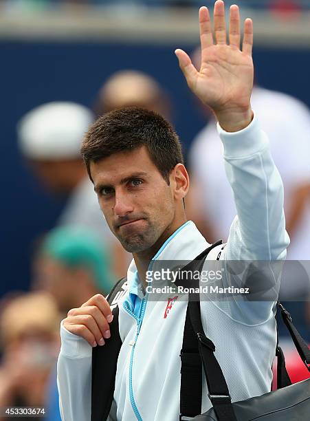 Novak Djokovic of Serbia waves as he walks off the court after a loss against Jo-Wilfried Tsonga of France during Rogers Cup at Rexall Centre at York...